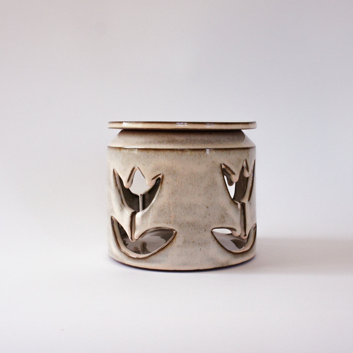 Large jar with cut-out flowers and light powder pink glaze