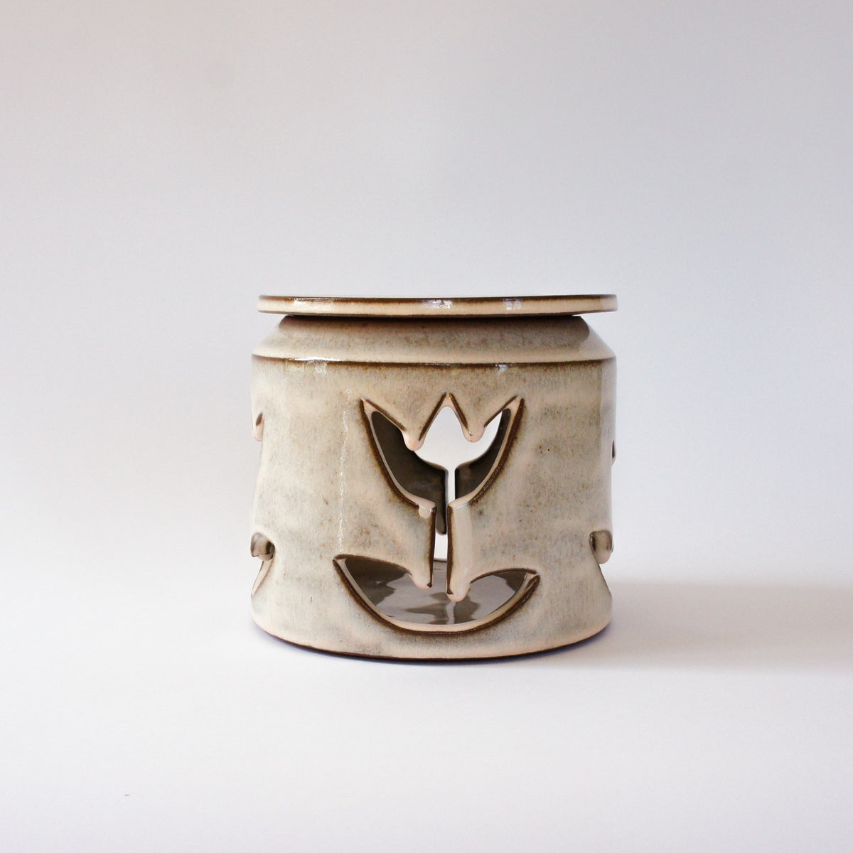 Large jar with cut-out flowers and light powder pink glaze