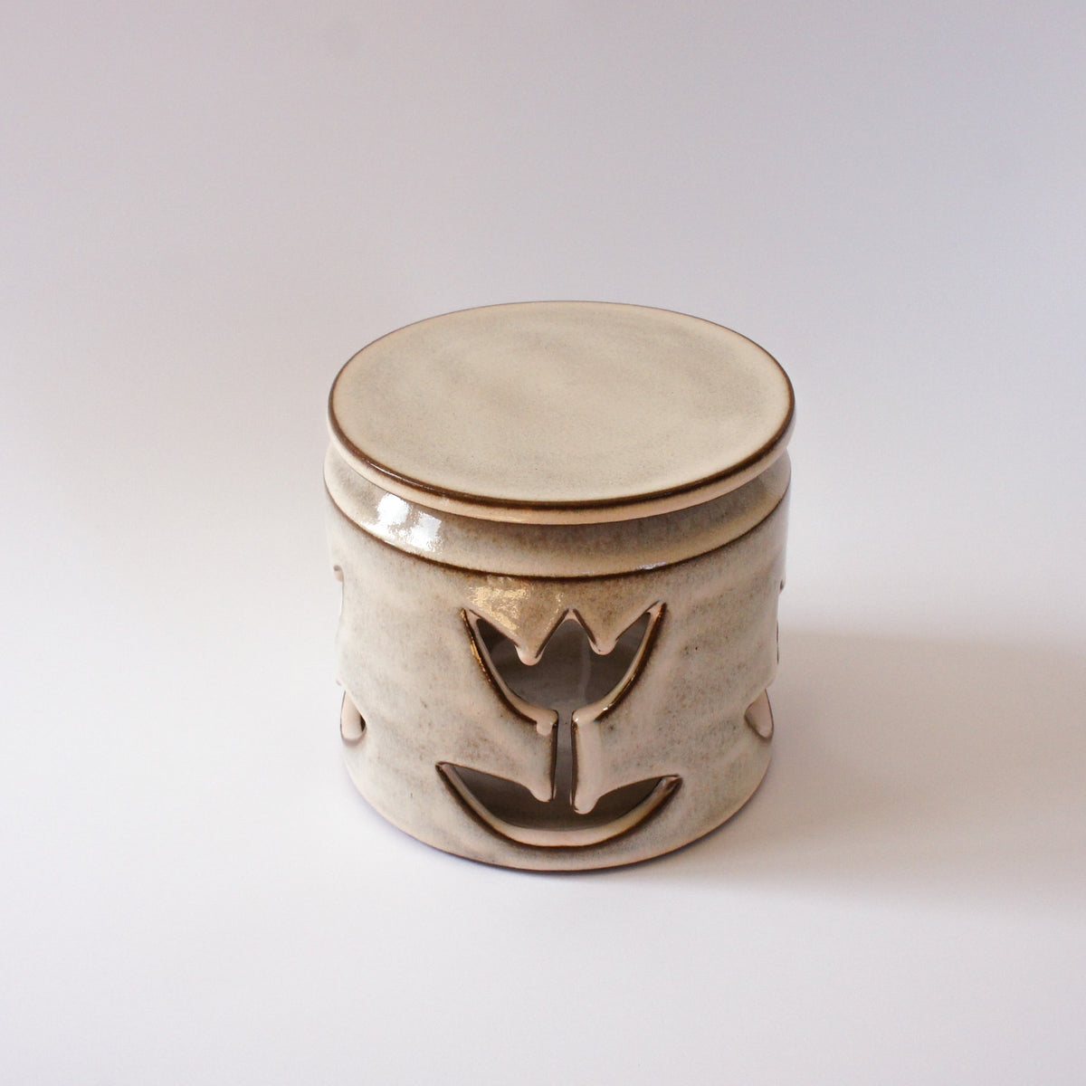 Large jar with cut-out flowers and light powder pink glaze
